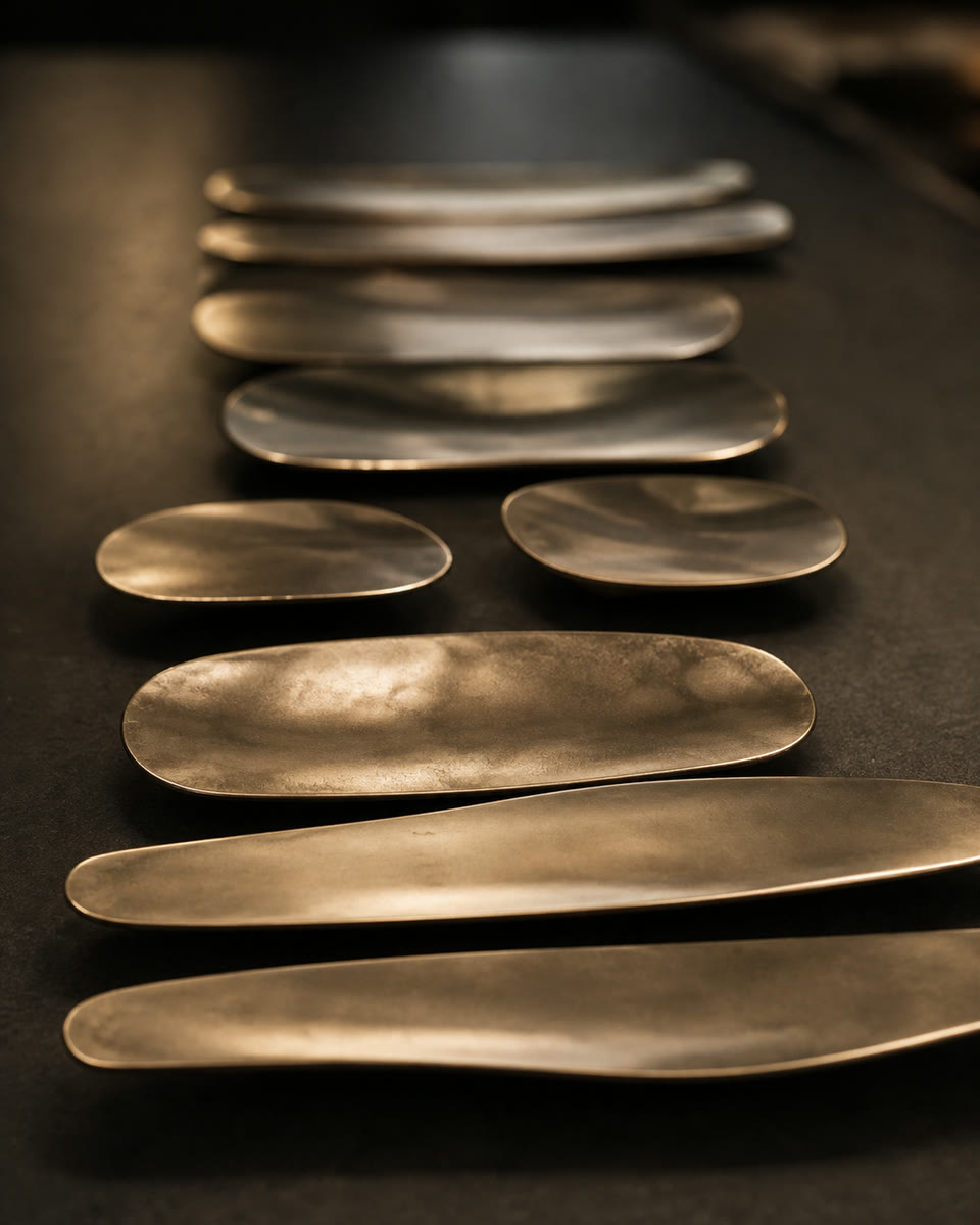 Forged bronze pulls lined up on the bench