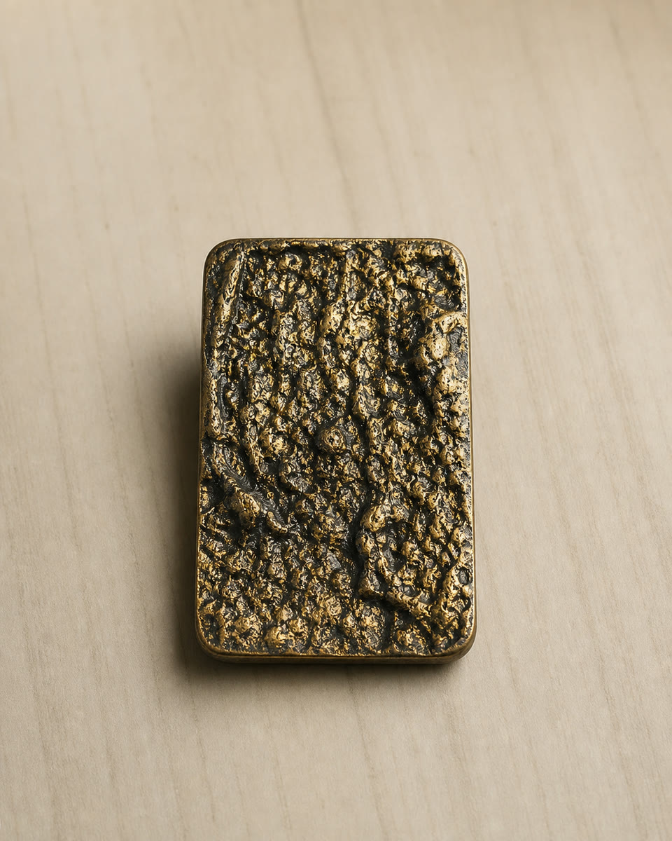 Raw cast bronze block on timber