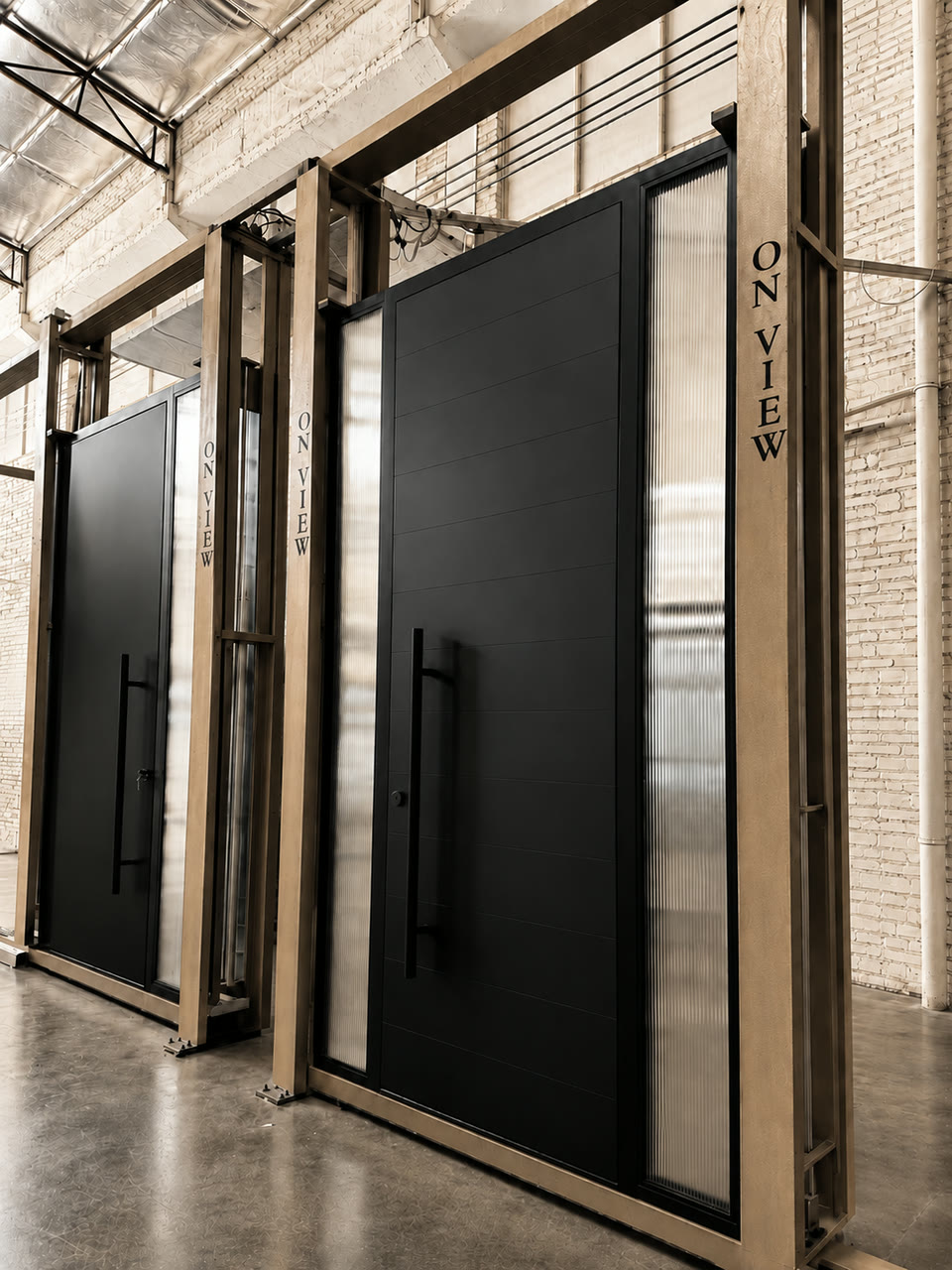 Pivot doors standing in test frames in the workshop