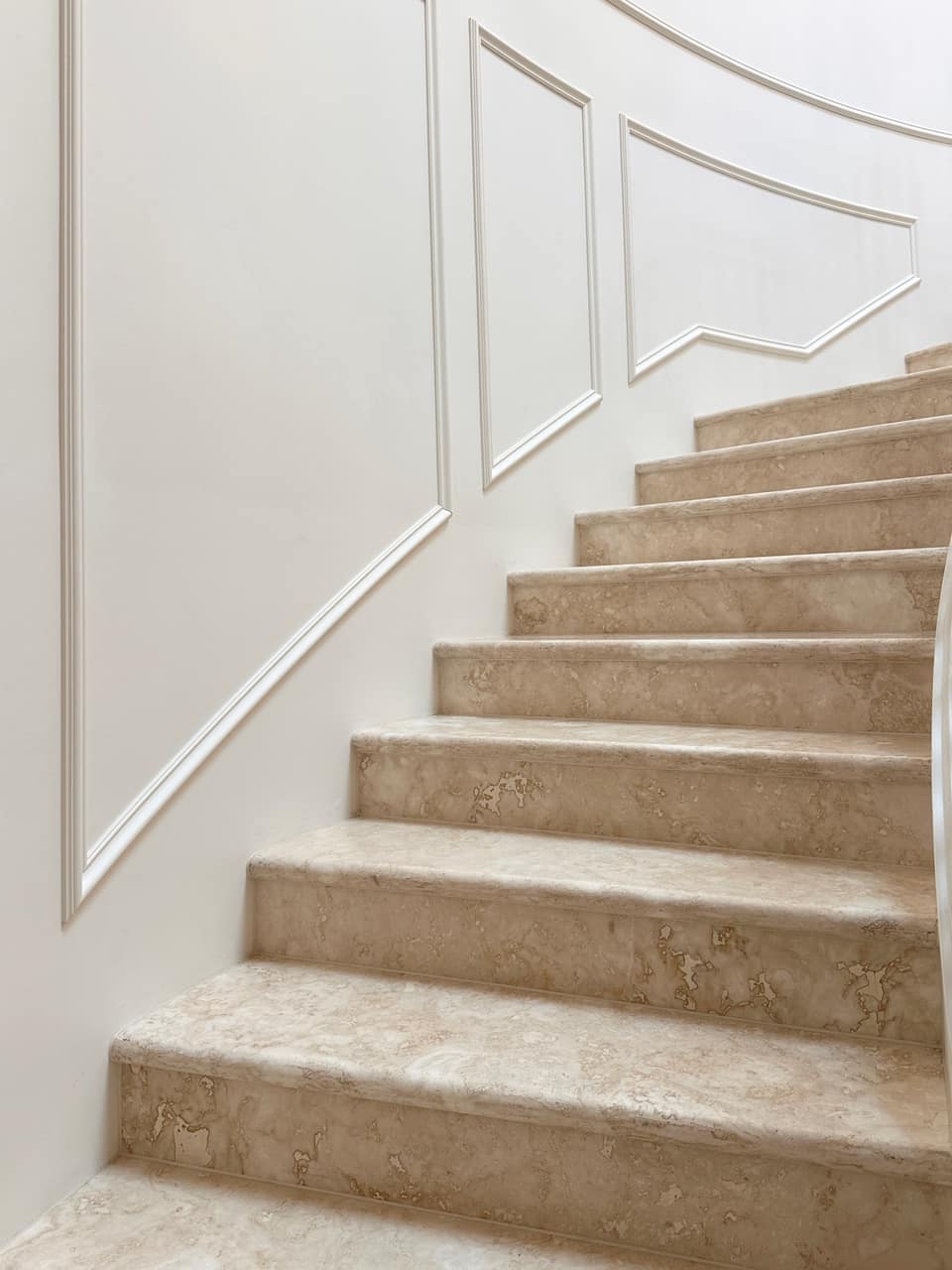 Straight-flight staircase with glass balustrade and stone treads