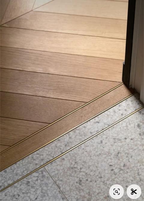 Wide-plank stone flooring in a Brighton entry hall